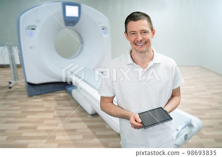 Doctor on the background of a CT scanner Doctor on the background of a CT scanner 98693835