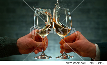 Freeze Motion Shot of Clinking Two Glasses of Wine, Close-up Freeze Motion Shot of Clinking Two Glasses of Wine, Close-up 98693952