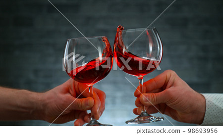 Freeze Motion Shot of Clinking Two Glasses of Wine, Close-up 98693956