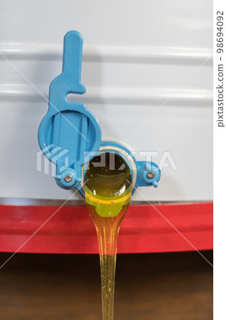 Drop of bee honey drip from hexagonal honeycombs Drop of bee honey drip from hexagonal honeycombs 98694092