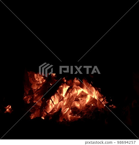 Beautiful flame brown wood dark black coal on bright yellow fire inside metal brazier Beautiful flame brown wood dark black coal on bright yellow fire inside metal brazier 98694257