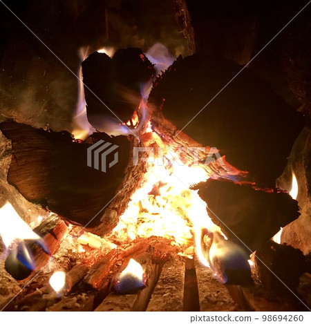 Beautiful flame brown wood dark black coal Beautiful flame brown wood dark black coal 98694260