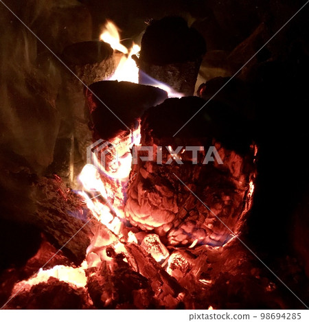 Beautiful flame brown wood dark black coal Beautiful flame brown wood dark black coal 98694285