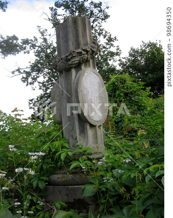 Old abandoned Jewish cemetery with stone graves between trees Old abandoned Jewish cemetery with stone graves between trees 98694350