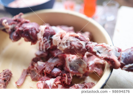 Preparing raw meat for barbecue close-up. Preparing raw meat for barbecue close-up. 98694876