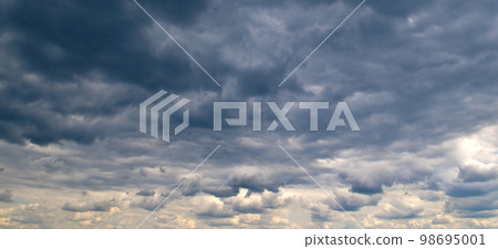Black storm clouds and bright horizon Black storm clouds and bright horizon 98695001