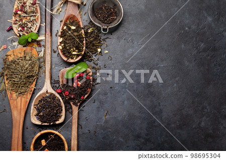 Various dried tea in wooden spoons Various dried tea in wooden spoons 98695304