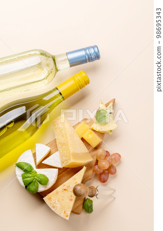 Various cheese on board and white wine Various cheese on board and white wine 98695343