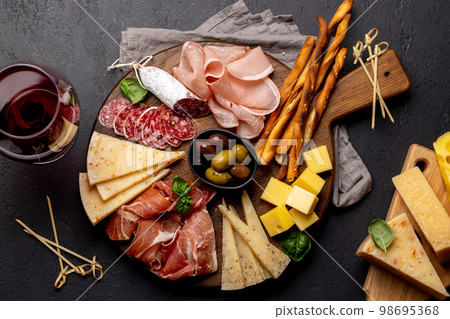 Antipasto board with various meat and cheese snacks 98695368