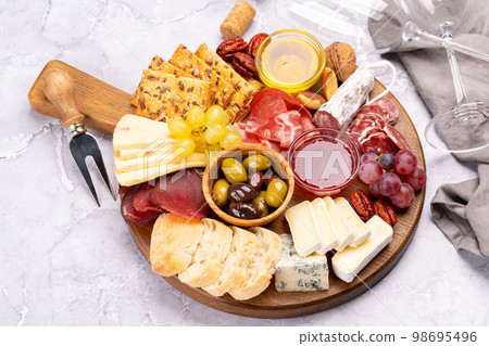Antipasto board with prosciutto, salami, crackers, cheese 98695496