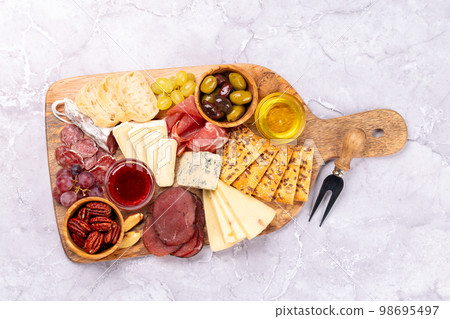 Antipasto board with prosciutto, salami, crackers, cheese 98695497