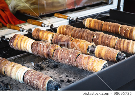 Trdelnik on barbeque on the street market in Prague Trdelnik on barbeque on the street market in Prague 98695725