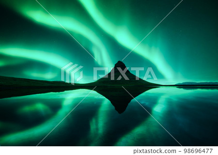Aurora borealis Northern lights over Kirkjufell mountain Aurora borealis Northern lights over Kirkjufell mountain 98696477