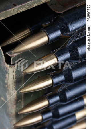 Ammo box with ammunition belt and 14.5mm cartridges for a 14.5mm KPVT heavy machine gun used by the former Soviet Union isolated on white background. Ammo box with ammunition belt and 14.5mm cartridges for a 14.5mm KPVT heavy machine gun used by the former Soviet Union isolated on white background. 98696772