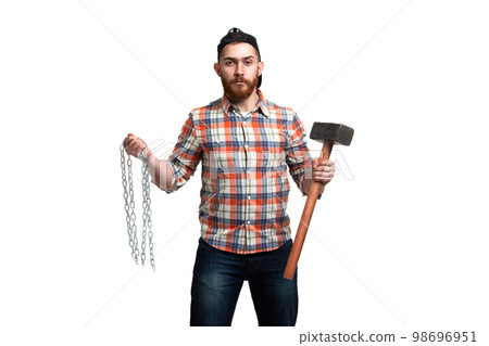 Serious bearded man in cap and checked shirt, holds hammer and chains in hands on white background Serious bearded man in cap and checked shirt, holds hammer and chains in hands on white background 98696951