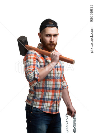 Serious bearded man in cap and checked shirt, holds hammer and chain isolated on white background Serious bearded man in cap and checked shirt, holds hammer and chain isolated on white background 98696952
