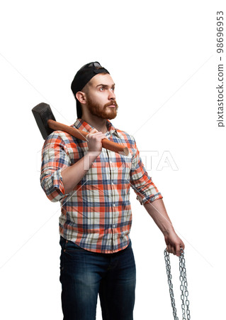 Serious bearded man in cap and checked shirt, holds sledgehammer and chains on white background Serious bearded man in cap and checked shirt, holds sledgehammer and chains on white background 98696953