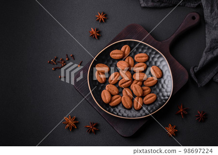 Delicious chocolate cookies with nuts on a black ceramic plate 98697224