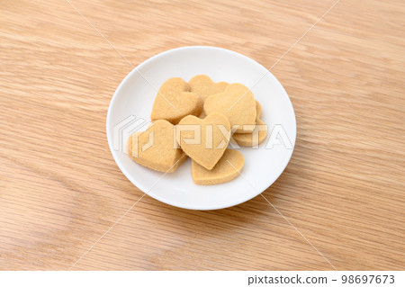 Heart-shaped handmade cookies on a white plate Valentine's Day White Day Heart-shaped handmade cookies on a white plate Valentine's Day White Day 98697673