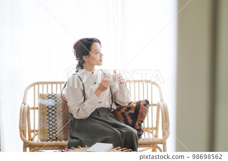 A woman relaxing in the room A woman relaxing in the room 98698562
