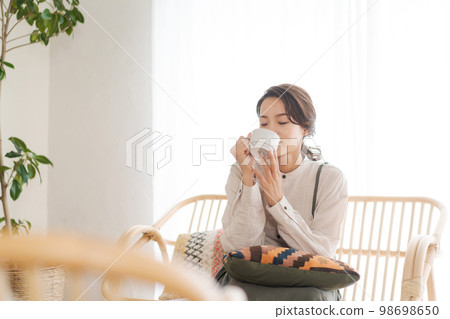 A woman relaxing in the room A woman relaxing in the room 98698650