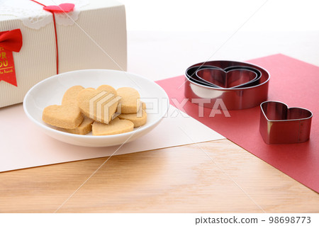 Heart-shaped handmade cookies on a white plate Valentine's Day White Day gift box 98698773