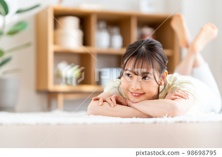 A woman relaxing in the living room. A woman relaxing in the living room. 98698795