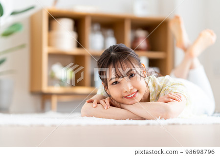 A woman relaxing in the living room. A woman relaxing in the living room. 98698796