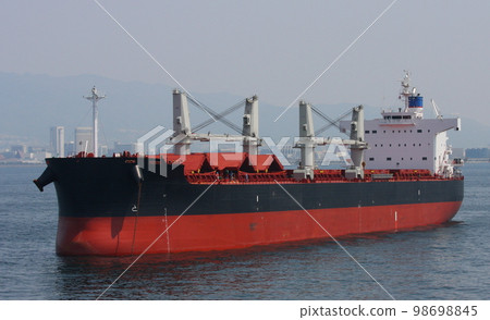 A bulk carrier anchored off the coast of Kobe Port 98698845