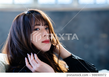 在別緻房間的沙發上放鬆的酷女人 98698972