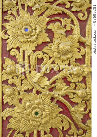 Golden stucco flower wall art in Thai temple Golden stucco flower wall art in Thai temple 98699281