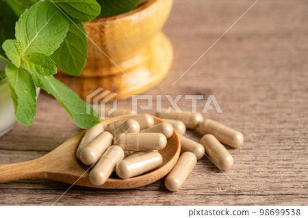 Alternative medicine herbal organic capsule drug with herbs leaf natural supplements for healthy good life. Alternative medicine herbal organic capsule drug with herbs leaf natural supplements for healthy good life. 98699538