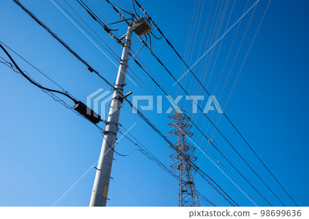 Electric wires and high-voltage transmission lines in the intersecting residential area and the clear sky a-1 Electric wires and high-voltage transmission lines in the intersecting residential area and the clear sky a-1 98699636
