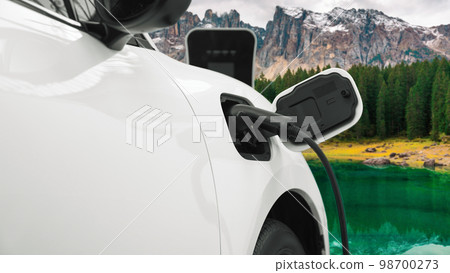 Progressive travel concept by EV car in remote mountain with charging station. 98700273