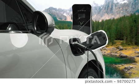 Progressive travel concept by EV car in remote mountain with charging station. Progressive travel concept by EV car in remote mountain with charging station. 98700275
