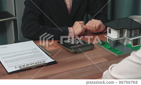 Closeup enthusiastic customer review contract paperwork for house loan. 98700768