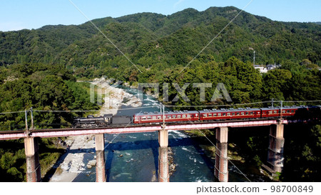 Aerial view of Chichibu Railway SL Pareo passing Arakawa Bridge 98700849