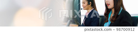 Business people wearing headset working in office in widen view Business people wearing headset working in office in widen view 98700912