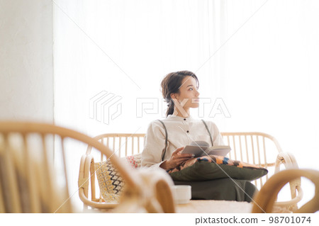 A woman relaxing in the room 98701074
