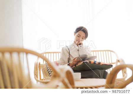 A woman relaxing in the room A woman relaxing in the room 98701077