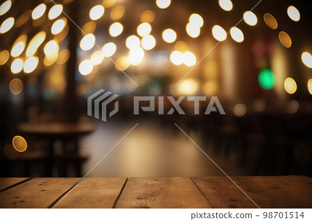 Empty wood table for product display in blur background of restaurant at night Empty wood table for product display in blur background of restaurant at night 98701514