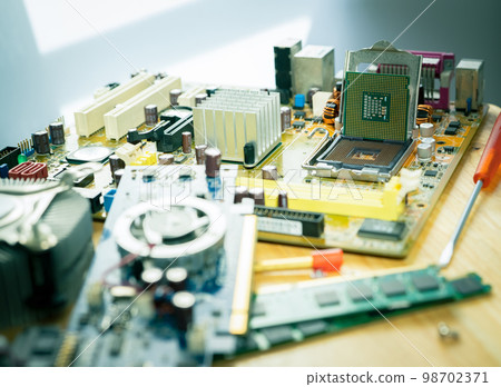 Selective focus computer chip on socket. Chipset on electronic circuit board of PC motherboard at repair workshop. CPU chip. Electronic components. Computer hardware. Upgrade computer processor chip. 98702371