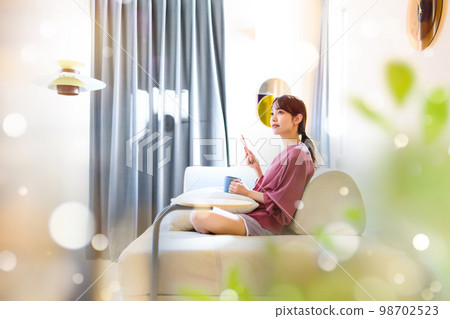 A woman in her 20s spending time at home 98702523