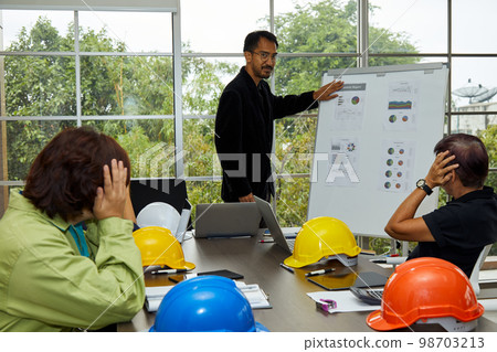 Chief engineer present summary report attached on white board in construction site Chief engineer present summary report attached on white board in construction site 98703213
