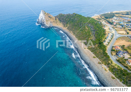 Aerial view of Keya no Daimon, a strangely shaped rock with columnar joints facing the Genkai Sea｜Drone shot｜Itoshima City, Fukuoka Prefecture 98703377