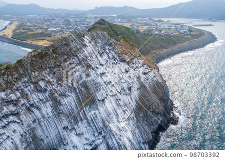 Aerial view of Keya no Daimon, a strangely shaped rock with columnar joints facing the Genkai Sea｜Drone shot｜Itoshima City, Fukuoka Prefecture 98703392