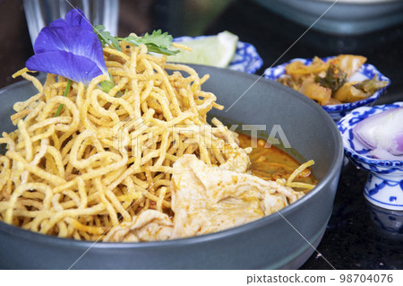 Khao Soi , Northern Thai Style Curried Noodle Soup with pork slide Khao Soi , Northern Thai Style Curried Noodle Soup with pork slide 98704076