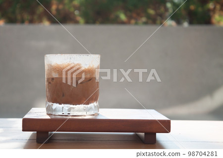 Iced coffee with micro foam in coffee shop 98704281