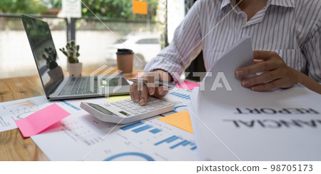 Close up usiness woman using calculator and laptop for do math finance on wooden desk in office and business working background, tax, accounting, statistics and analytic research concept Close up usiness woman using calculator and laptop for do math finance on wooden desk in office and business working background, tax, accounting, statistics and analytic research concept 98705173