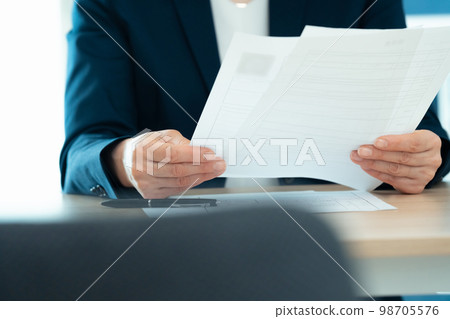 Personnel officer looking at application documents 98705576